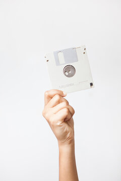 Hand with a diskette.