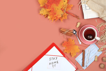 Autumn composition flat lay, computer, tea, mask, remote work, minimal business concept. Modern woman's work desk. Home office in a pandemic, stay home, protect yourself,top view