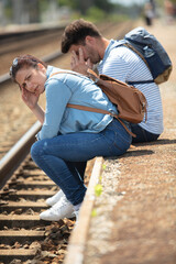 young couple waiting at train station