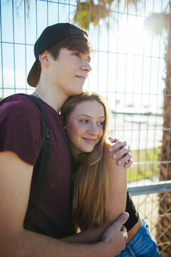 Portrait of a teen couple smiling in summer.