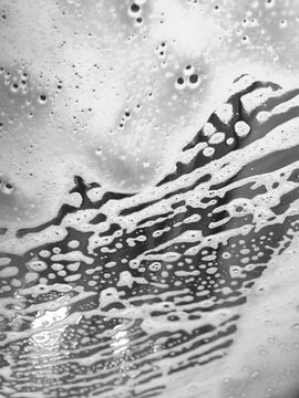 Close of soapy water on car windshield