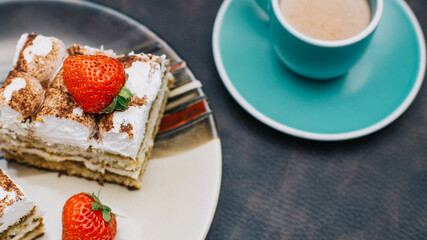 Homemade Tiramisu cake is a traditional Italian dessert with strawberries. Sweet dessert for Breakfast. Calories and excess weight