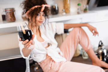 selective focus of woman holding glass of red wine