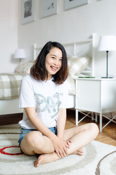 Portrait of young asian woman at home