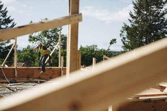 Construction worker jumping down with skill saw