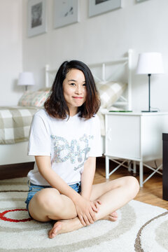 Portrait of young asian woman at home