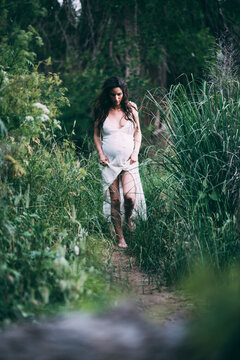 Pregnant Woman in the Woods by a River