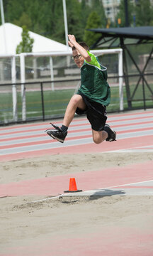 Boy Doing Long Jump At Track Meet