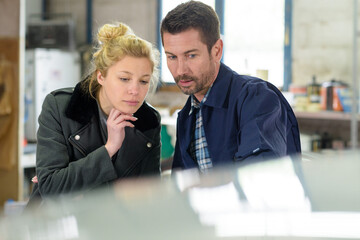 woman and man looking at something in workshop