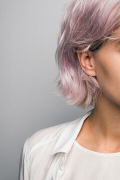 Close-up of pink-haired girl against of white background
