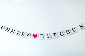 Hanging sign that says ""Cheers Bitches""