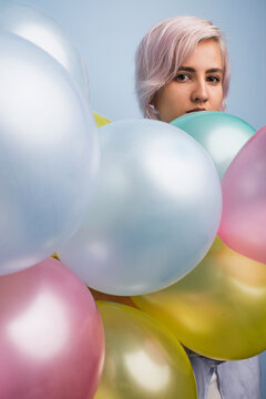 Portrait of beautiful young girl with colorful balloons