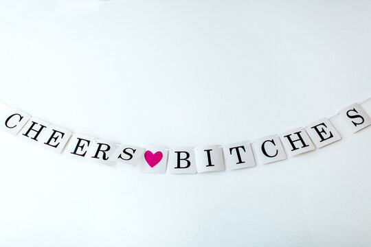 Hanging sign that says ""Cheers Bitches""