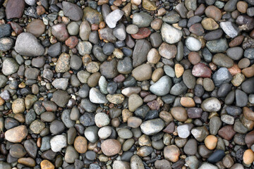 Rounded rocks on the beach for background