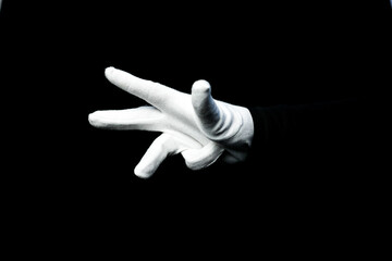 A hand wearing white glove on black background counting down