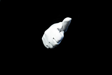 A hand wearing white glove on black background counting down