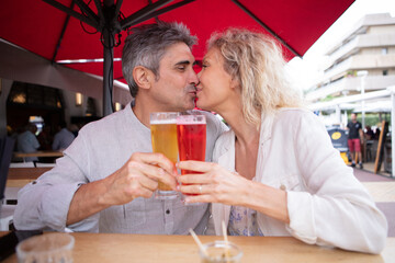 loving mature couple kissing at the bar terasse outdoor