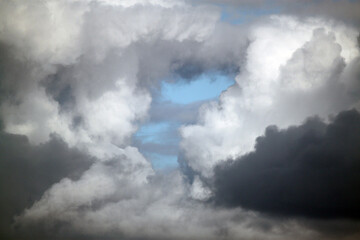 Large puffy gray and white clouds against a blue sky