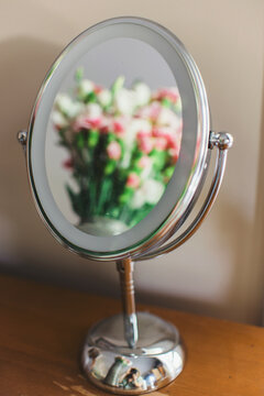 A reflection of flowers in a mirror
