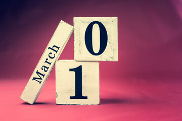 March 10th, Tenth of March, Day 10 of month March - vintage wooden calendar blocks on maroon...