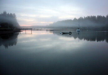 Fototapeta premium Peaceful seascapes with rippled water, buoys, boats, and dynamic skies and reflections