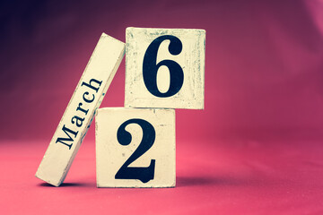 March 26th, Twenty-sixth of March, Day 26 of month March - vintage wooden calendar blocks on maroon background with empty space for text