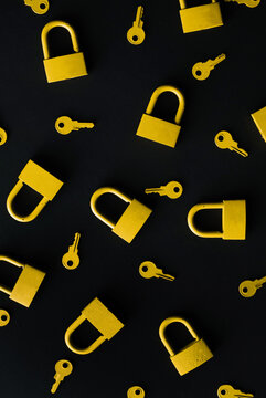 Yellow keys and locks on black background