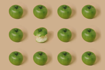 Trendy pattern made with fresh bitten apple fruit on pastel beige background. Minimal concept.