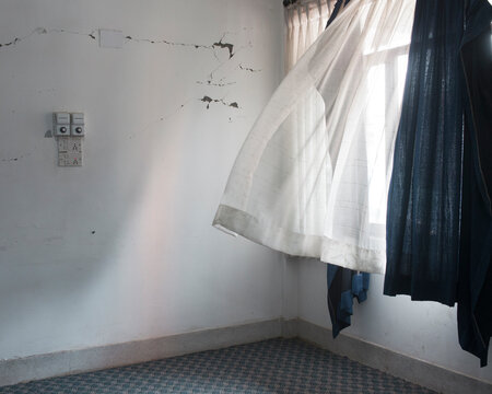 Wisp of wind inside an empty broken room.