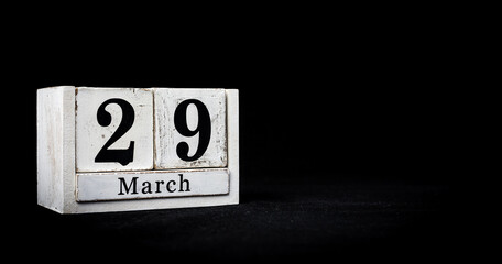 March 29th, Twenty-ninth of March, Day 29 of month March - white calendar blocks on black textured background with empty space for text.