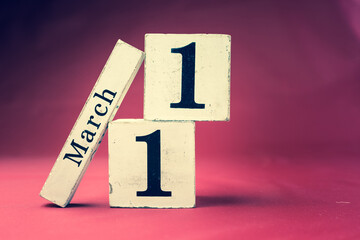 March 11th, Eleventh of March, Day 11 of month March - vintage wooden calendar blocks on maroon...