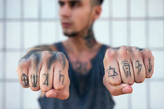 Close-up of tattooed man's knuckles