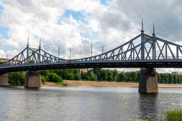 Tver Russia June 2017. Automobile iron bridge over the Volga River on the background of a sandy beach