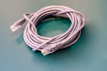gray lag cable with rj 45 connector long folded in a skein lies on the table