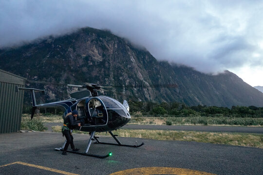 Photographer disembarks a helicopter.