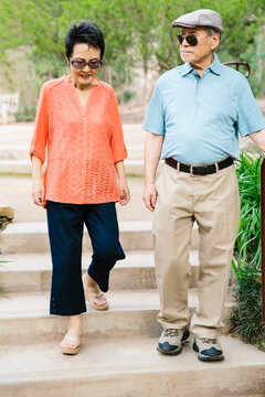 Asian mand and woman walking down steps