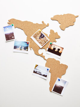 Cork map with polaroid photos pinned on it