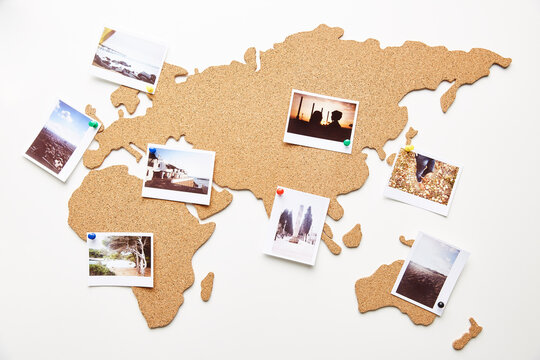 Summer polaroid photos on cork map with pins