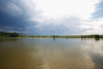 Dramatic clouds over the lake. Sunset.