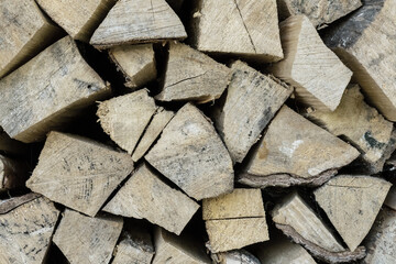 chipped wooden logs stacked in a woodpile pattern rustic beige