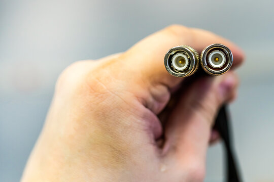 cable coax for signal transmission cable television end in male hands close-up