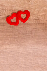 base design, a pair of red hearts a symbol of love, Valentine's Day lies on a wooden background copy space