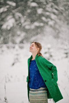 Cheerful woman in snowfall
