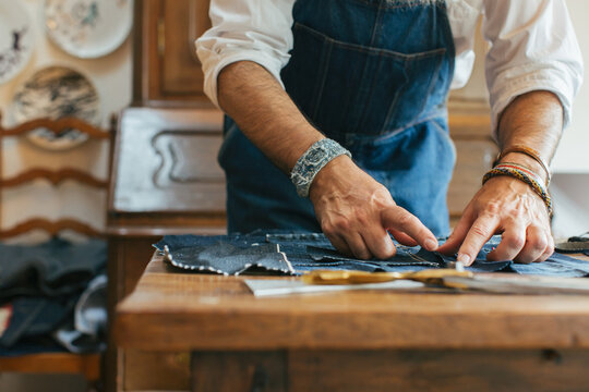 Closeup of Cool Senior Tailor Working on Boro Denim Patchwork