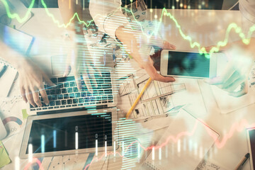 Multi exposure of man and woman working together and forex graph hologram drawing. Financial analysis concept. Computer background. Top View.