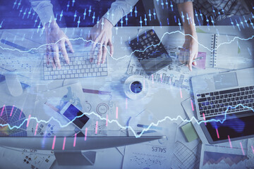 Double exposure of man and woman working together and financial chart hologram drawing. market analysis concept. Computer background. Top View.