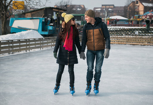 Couple Ice Skating and Holding Hands