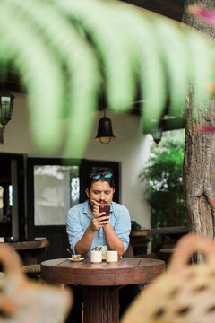 Man with a focused expression reading on his mobile phone.