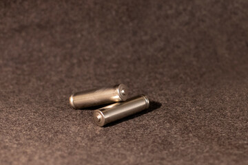 two rechargeable batteries lie on a gray background