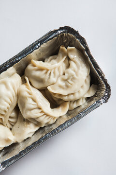 Takeaway momo's on a white background.